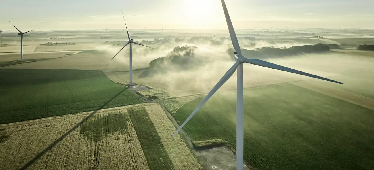 The Marketplace for Wind Project Sites Wind turbine on a field at sunrise.